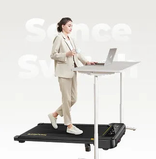A professional uses a Toputure treadmill at their desk, combining work and exercise.