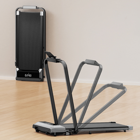 The Toputure walking pad folds vertically with its handlebars lowered, storing compactly against a wall to save space.