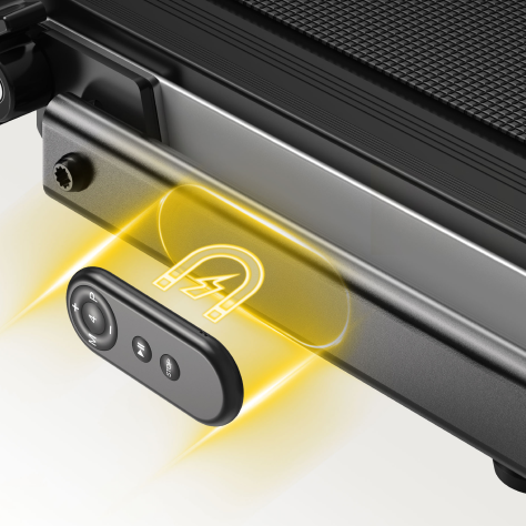 Hand placing the Toputure treadmill remote onto its magnetic docking spot on the console, showcasing neat and effortless storage.