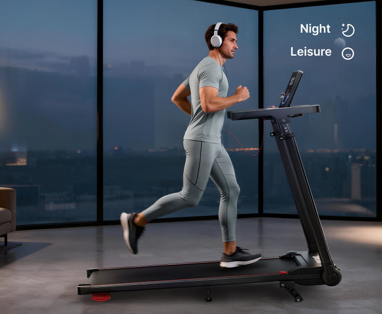 A man wearing headphones running on a treadmill at home during the night, showing an immersive and focused indoor workout atmosphere.
