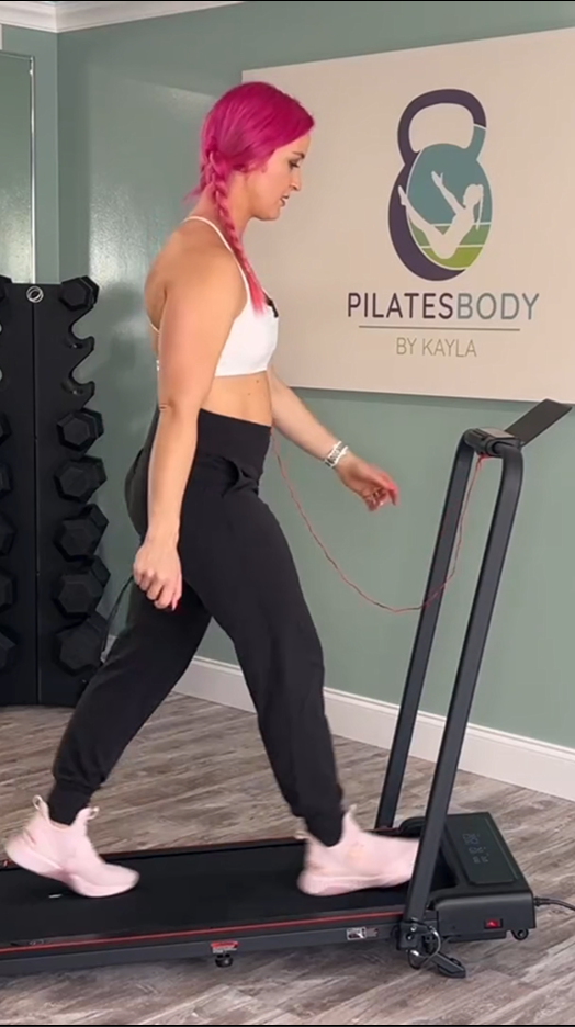 A woman walking naturally on a walking pad in her home, integrating gentle activity into her daily routine.
