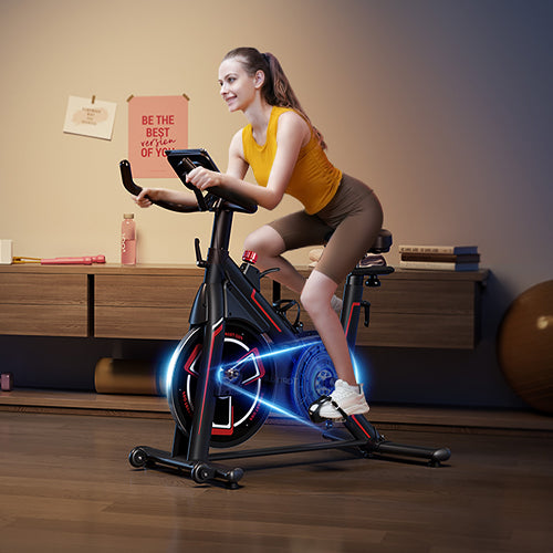 A woman cycling on a quiet exercise bike at night in her home, enjoying a peaceful and undisturbed workout.