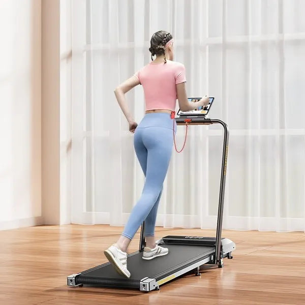 Person using a Toputure home treadmill in a room with light-colored curtains