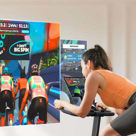 A cyclist uses an exercise bike connected to a fitness app, immersing themselves in a scenic virtual route for an engaging and fun workout.