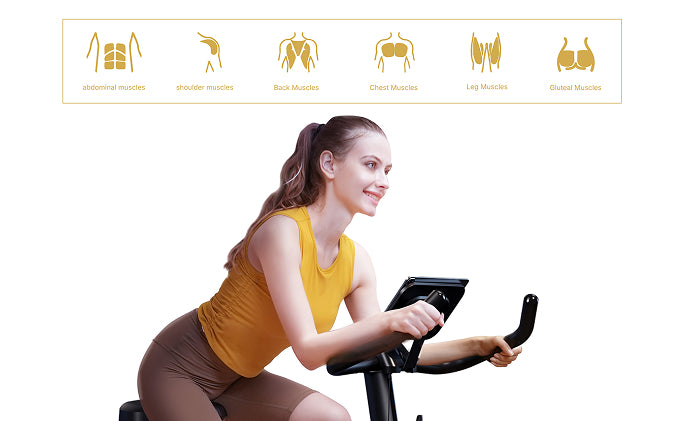 A woman cycling on an exercise bike at home, with graphics highlighting engaged muscle groups: legs, back, glutes, shoulders, chest, and abs.
