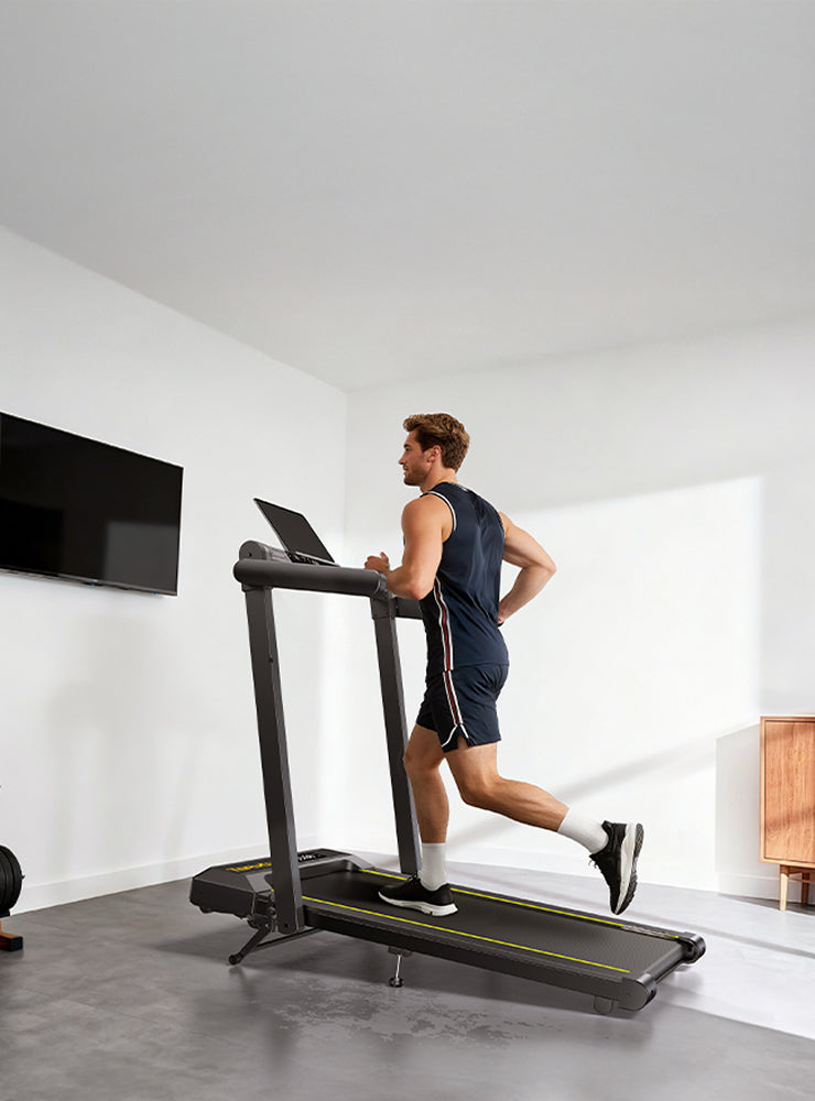 A man running on a Toputure TP5 treadmill in his modern home.