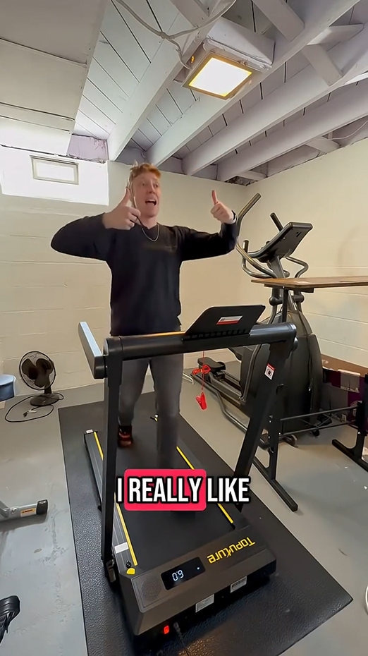 A satisfied man gives a thumbs-up while running on his home treadmill, endorsing a great workout experience.