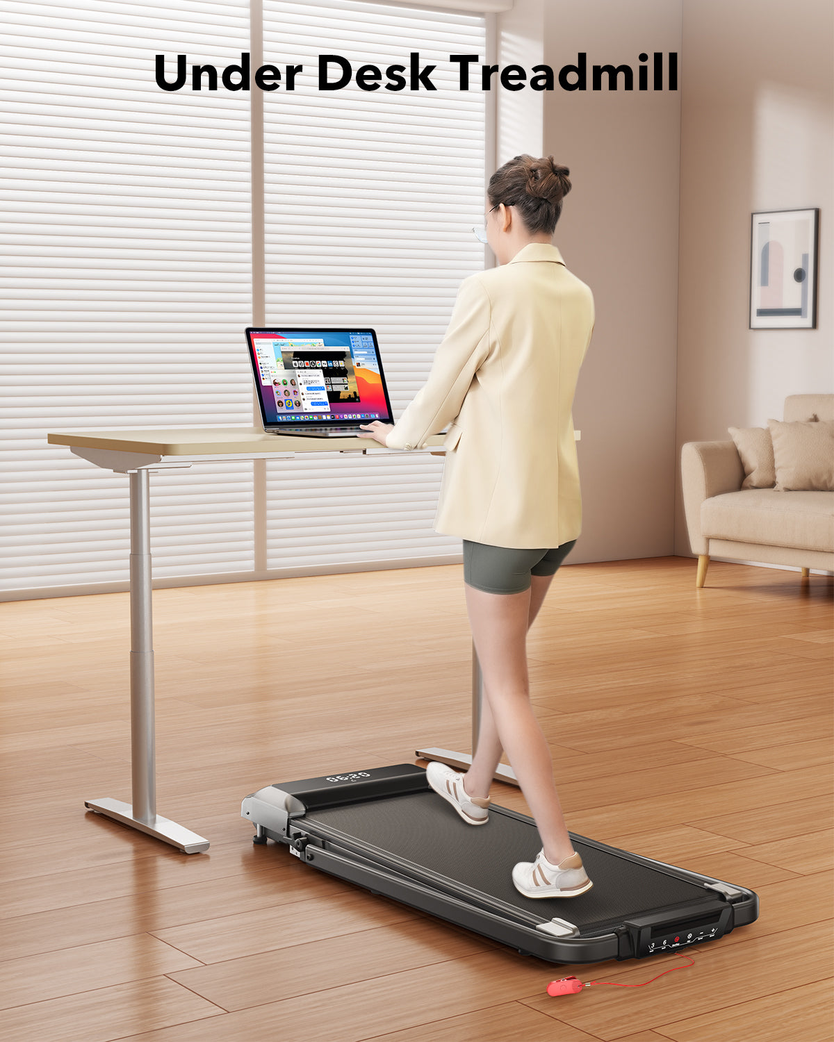 A woman works at her desk while walking on a Toputure under-desk treadmill, seamlessly integrating fitness into her workday.